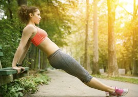 Beautiful girl doing push ups outdoor