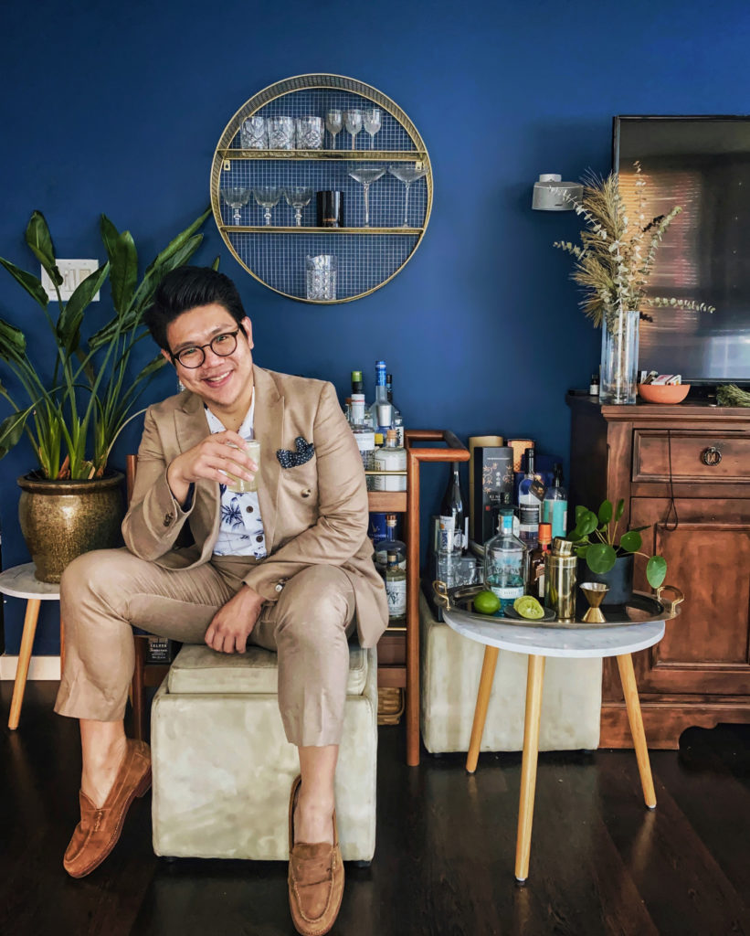 Viranlly Liemena sitting beside home bar