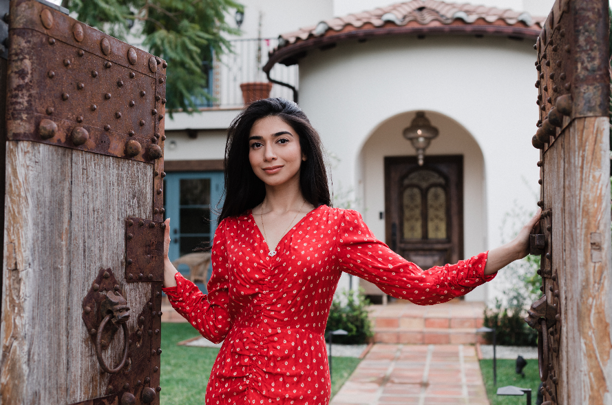 Shiza Shahid in red dress opening doors to her home