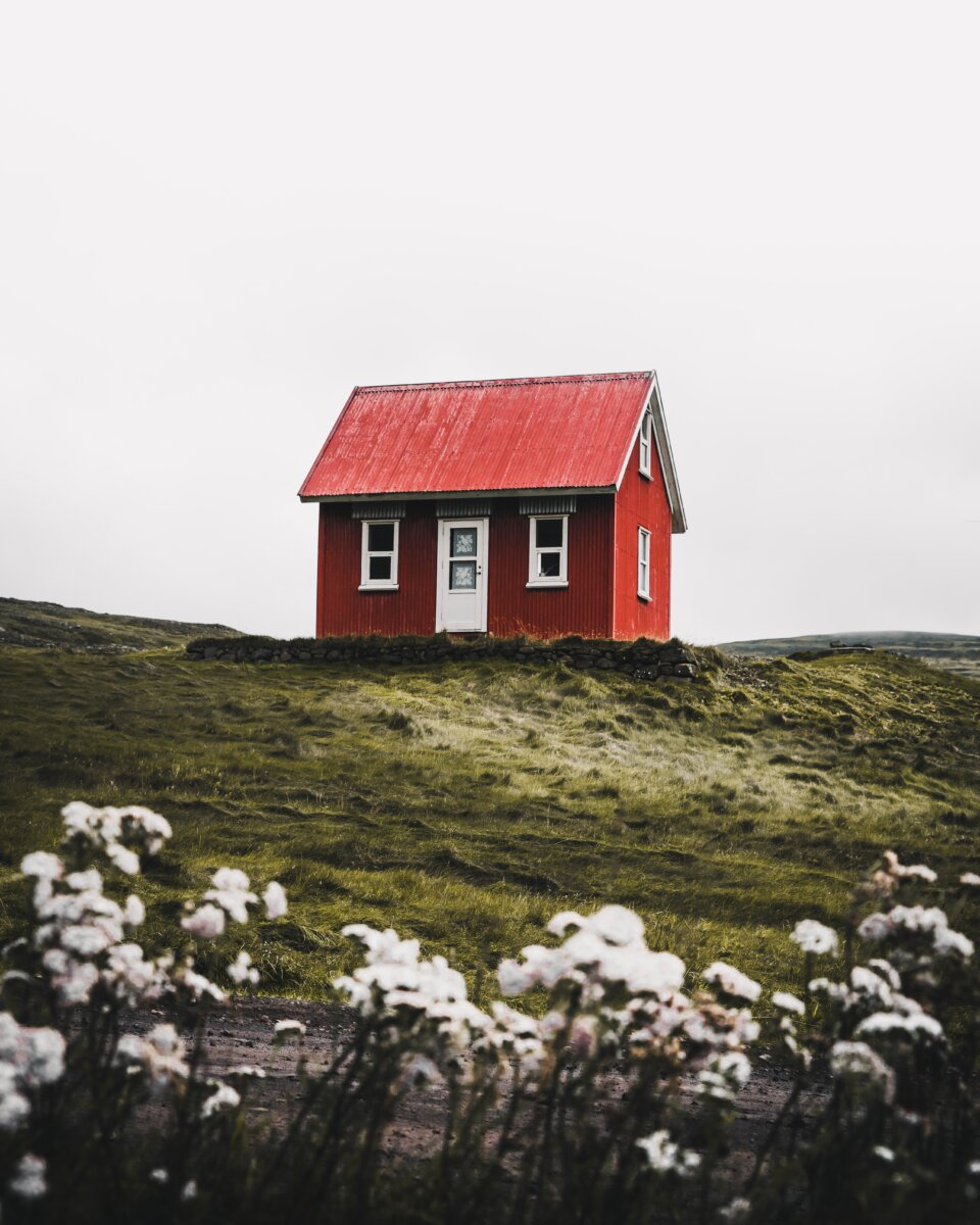 Small red house in rural countryside landscape