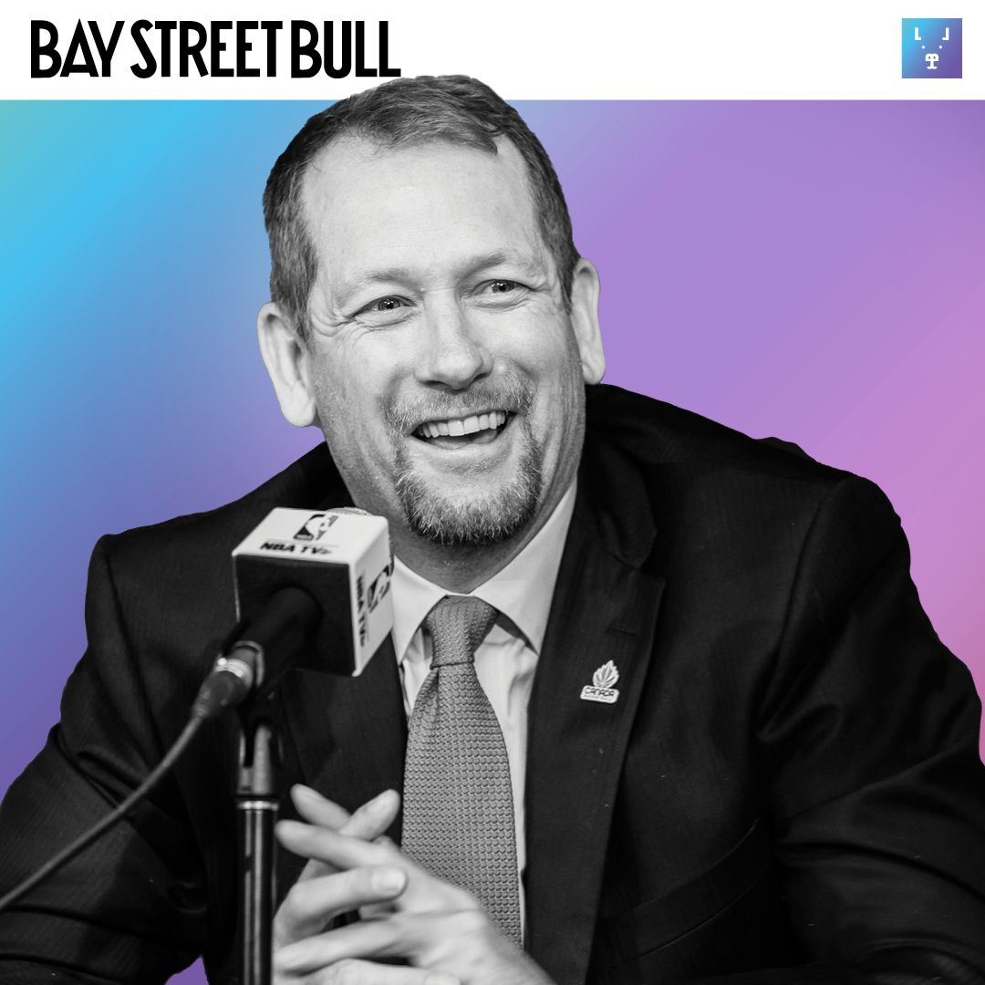 Nick Nurse with microphone smiling in suit and tie