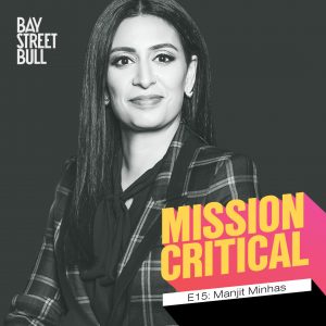 A black and white photo of Manjit Minhas, CEO of Minhas Brewery, Distillery and Winery, wearing a blouse and a plaid blazer. Bay St. Bull and mission critical branding.