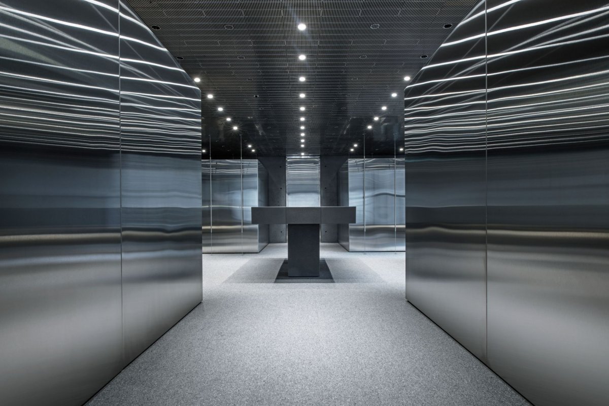 Mirrored hallway with minimal interiors and lighting at SSENSE