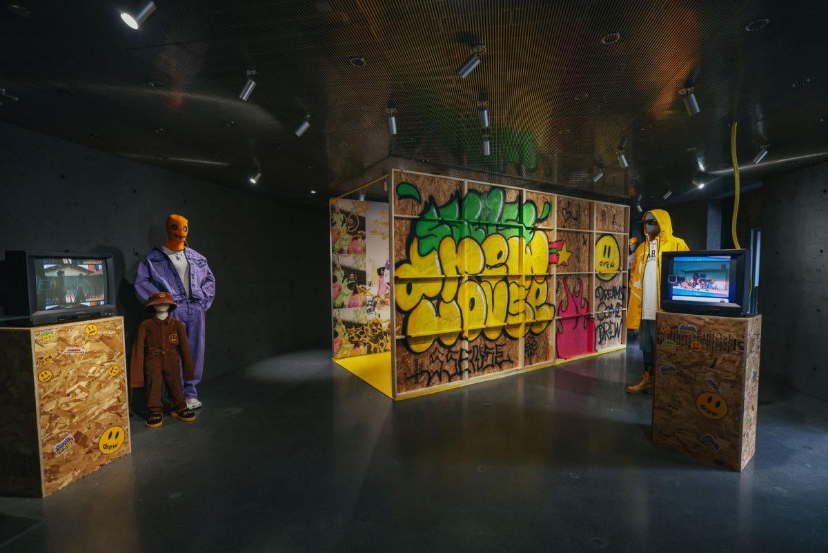 Dark showroom with clothing and wood showcase covered in graffiti